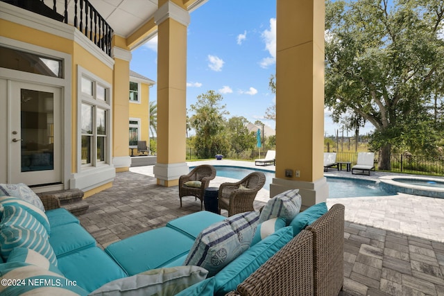 view of patio with a pool with hot tub, an outdoor hangout area, and a balcony