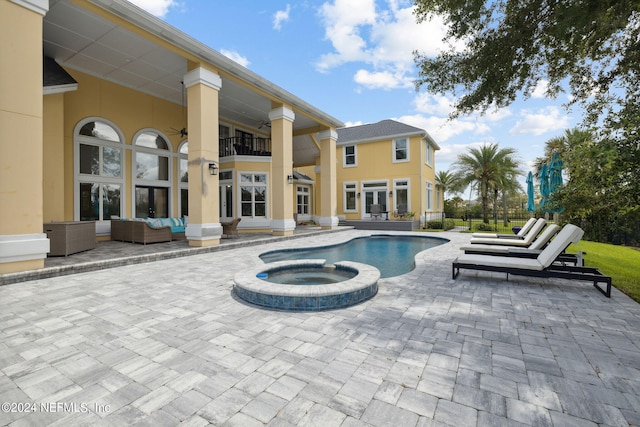 view of swimming pool with an in ground hot tub, an outdoor hangout area, and a patio area