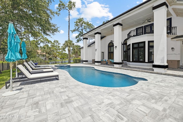 view of pool with an in ground hot tub, ceiling fan, and a patio