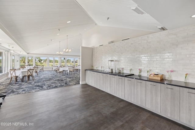 105 Teal Nest Ct, Ponte Vedra Beach, FL 32082 - kitchen with dark countertops, modern cabinets, high vaulted ceiling, and visible vents