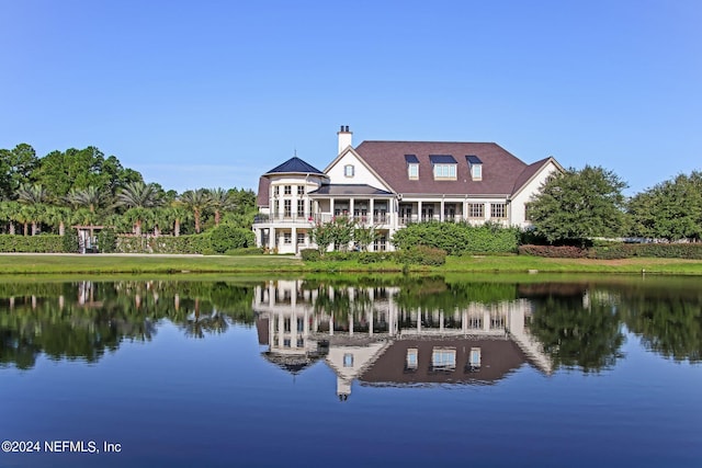 rear view of property featuring a water view