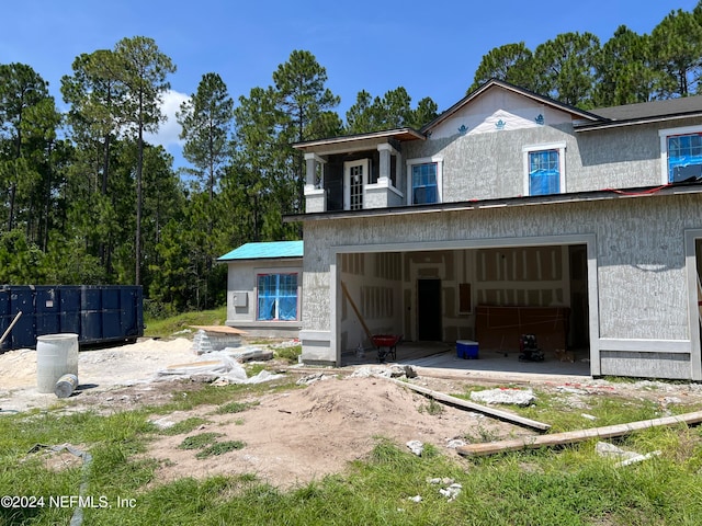 rear view of house featuring a garage