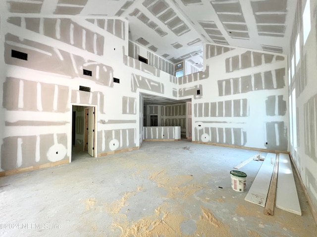 unfurnished living room with a high ceiling