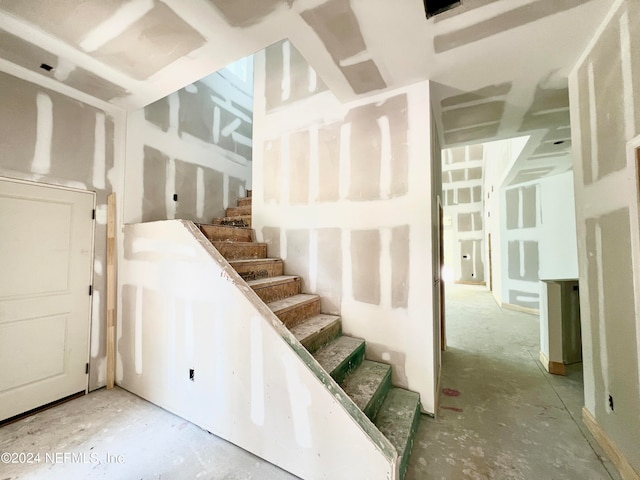 staircase with concrete floors