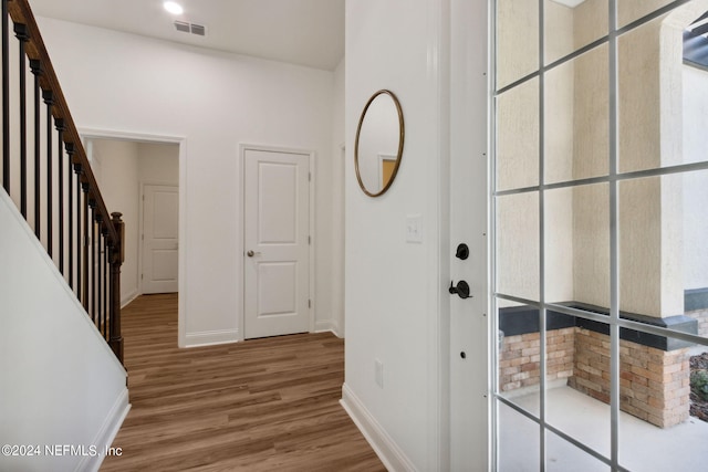 hallway with hardwood / wood-style flooring