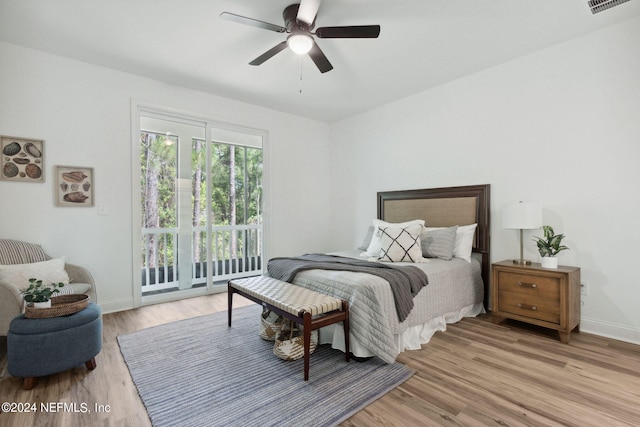 bedroom featuring access to outside, light hardwood / wood-style flooring, and ceiling fan