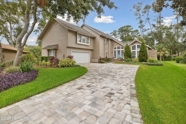 view of front of home featuring a garage and a front yard