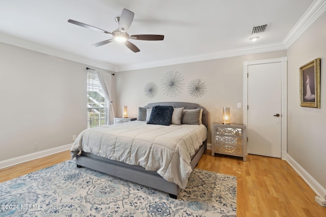 bedroom featuring ceiling fan, light hardwood / wood-style floors, and ornamental molding