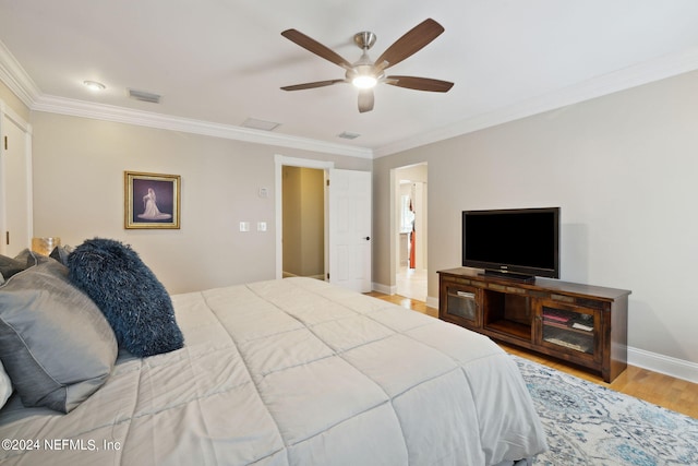 bedroom featuring ceiling fan, light wood-type flooring, and crown molding