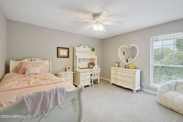 carpeted bedroom with a textured ceiling and ceiling fan