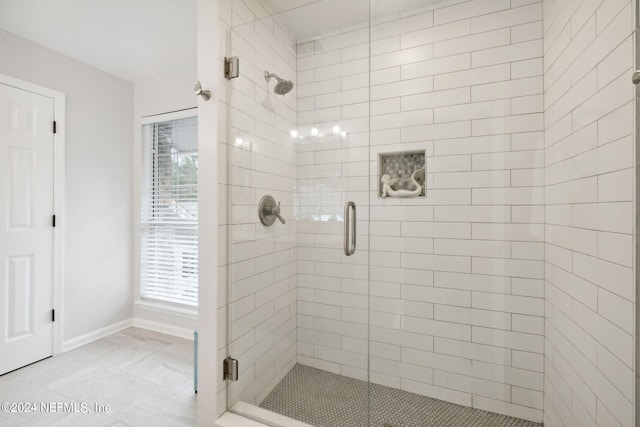 bathroom with a shower with shower door