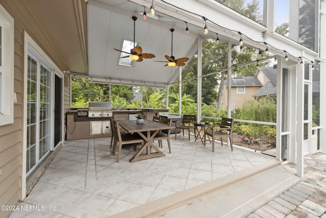 sunroom with ceiling fan and lofted ceiling