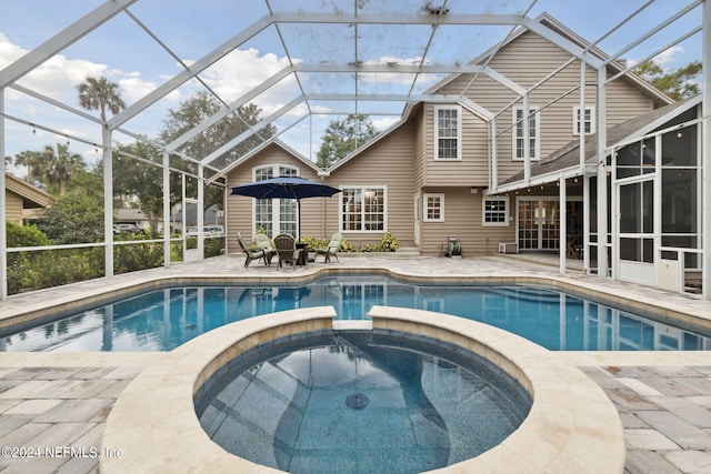 view of swimming pool with an in ground hot tub, a patio, a lanai, and a sunroom