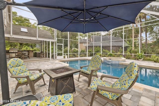 view of swimming pool with a fire pit, area for grilling, a patio area, and an in ground hot tub