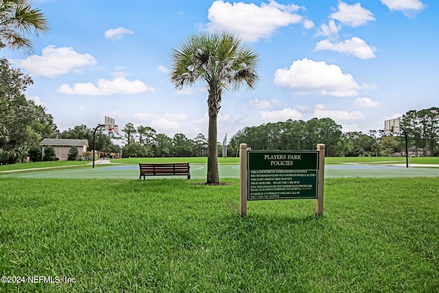 surrounding community with a lawn and basketball court