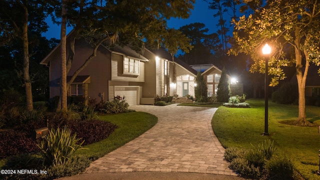 view of front facade featuring a yard and a garage