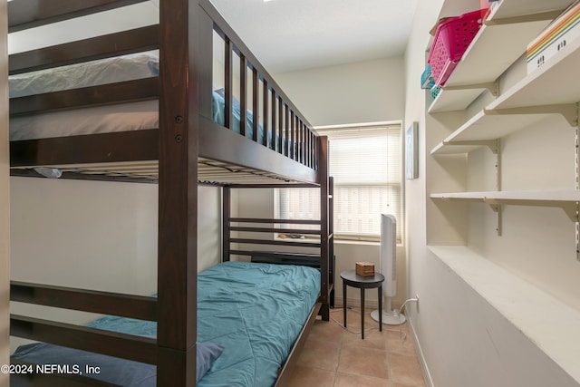 bedroom featuring baseboards and tile patterned floors