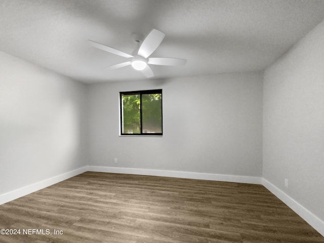 unfurnished room with ceiling fan and hardwood / wood-style flooring