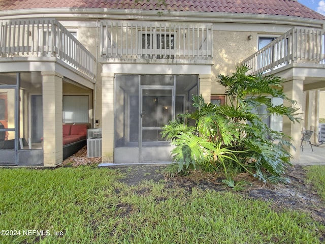 back of house with a sunroom and central air condition unit