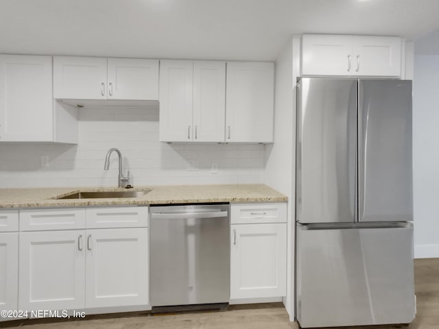 kitchen featuring sink, white cabinets, and appliances with stainless steel finishes