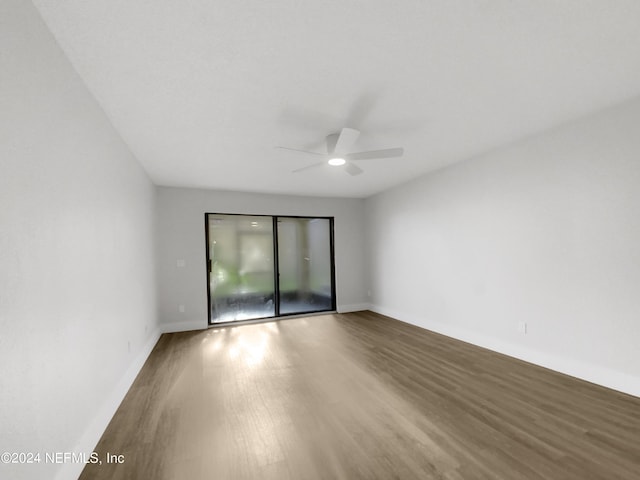 empty room with hardwood / wood-style flooring and ceiling fan