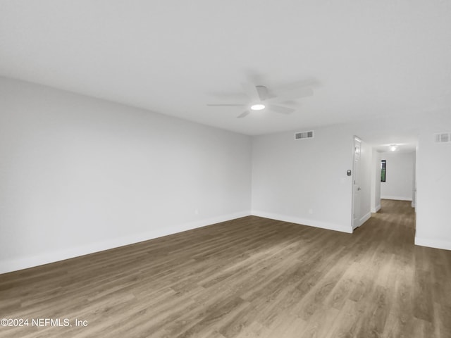 empty room with ceiling fan and wood-type flooring