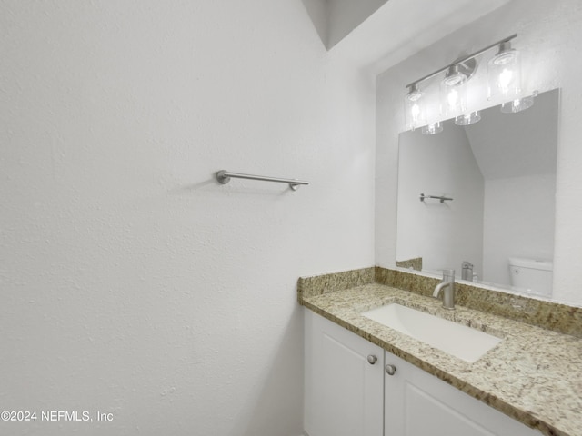 bathroom featuring toilet and vanity