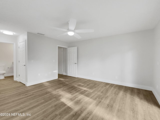 empty room featuring ceiling fan and hardwood / wood-style floors