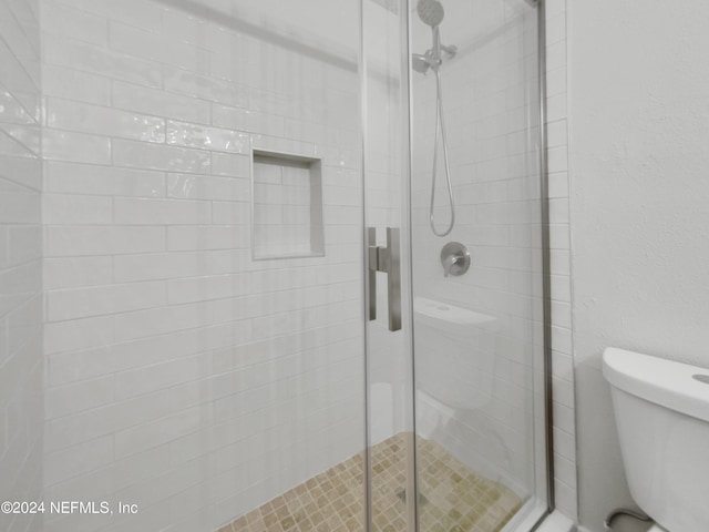 bathroom with toilet and walk in shower