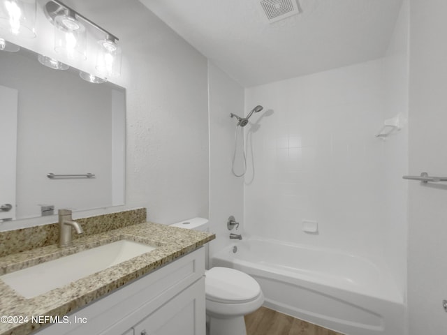 full bathroom featuring hardwood / wood-style flooring, toilet, vanity, and shower / bathtub combination