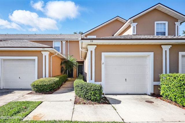 traditional-style home featuring stucco siding and driveway