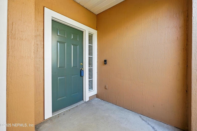 property entrance with stucco siding