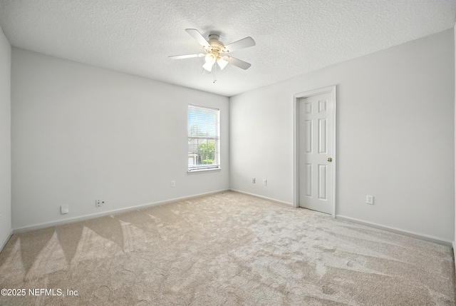 unfurnished room featuring ceiling fan, a textured ceiling, carpet flooring, and baseboards