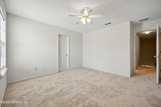 unfurnished bedroom with carpet floors, a textured ceiling, baseboards, and a ceiling fan