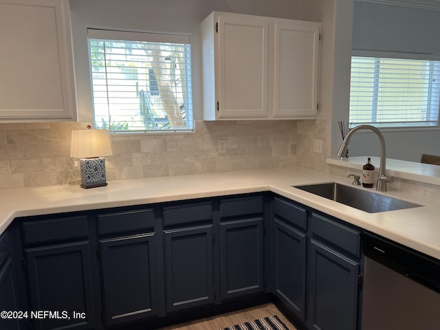 kitchen with a healthy amount of sunlight, sink, stainless steel dishwasher, and white cabinets