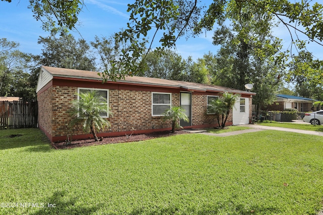 ranch-style house with a front lawn