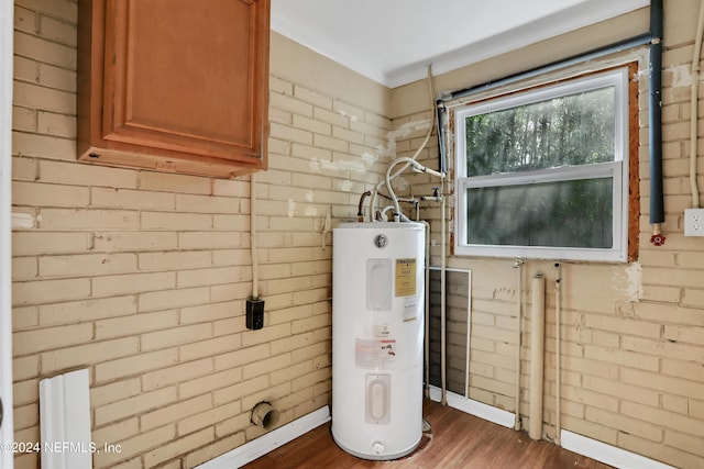 utility room featuring water heater