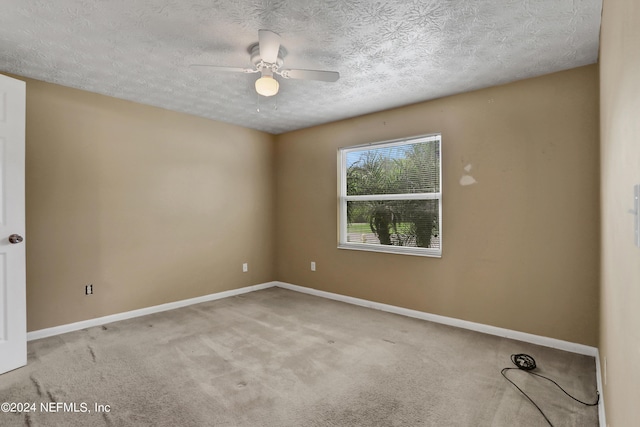 unfurnished room with ceiling fan, a textured ceiling, and carpet flooring