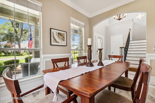 dining room with crown molding, a notable chandelier, and a wealth of natural light