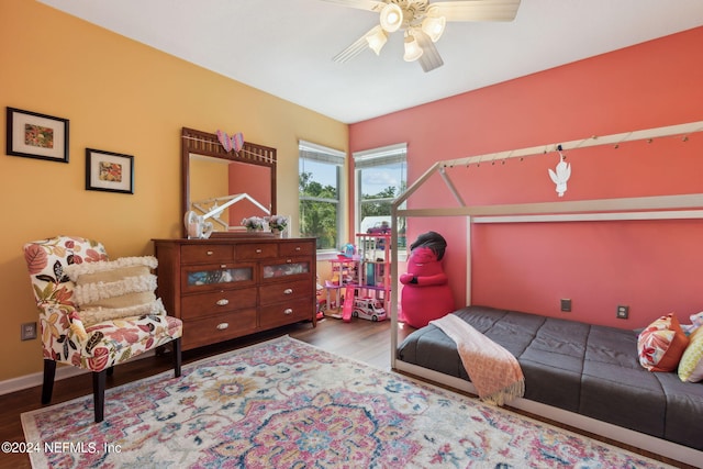 bedroom with hardwood / wood-style floors and ceiling fan