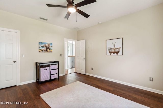 unfurnished bedroom featuring dark wood-type flooring and ceiling fan