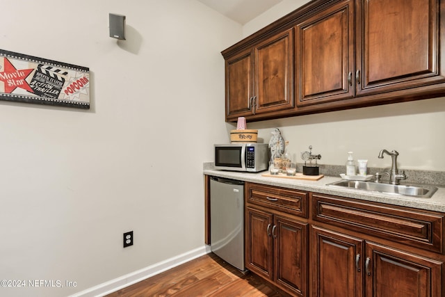 kitchen featuring dark hardwood / wood-style flooring, sink, and stainless steel appliances