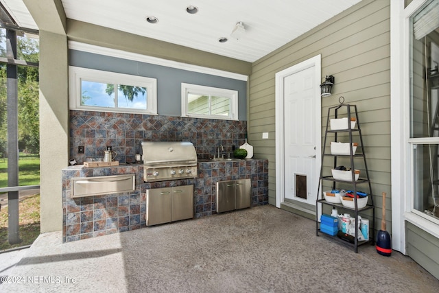 view of patio / terrace with sink, grilling area, and an outdoor kitchen