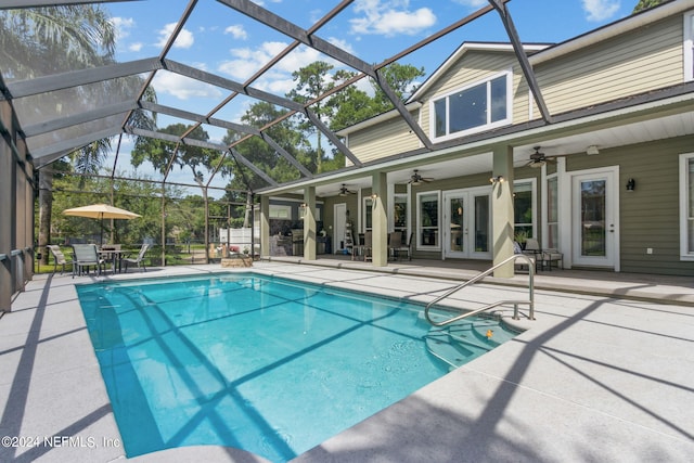 view of swimming pool with a patio, a lanai, ceiling fan, and french doors