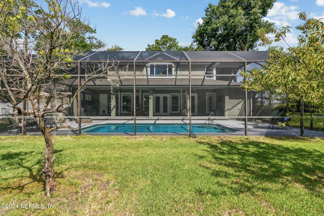 back of house with a yard, a patio, and glass enclosure