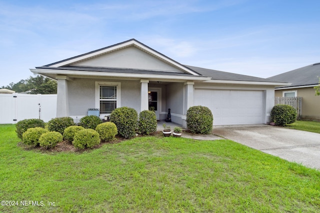 view of front of home with a garage, covered porch, and a front lawn