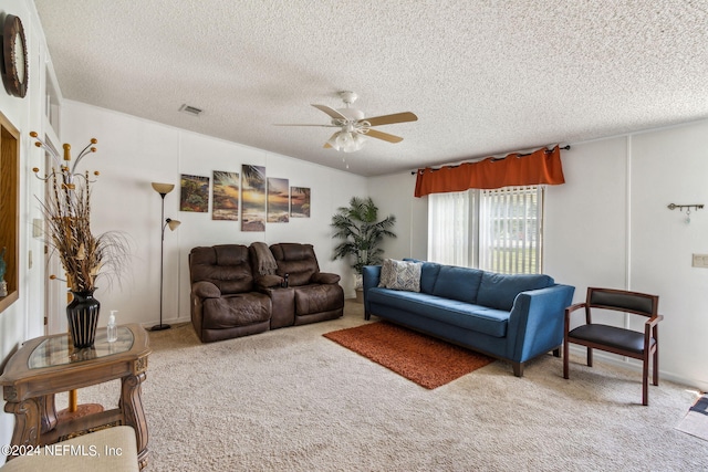 living room with ceiling fan, carpet, and a textured ceiling