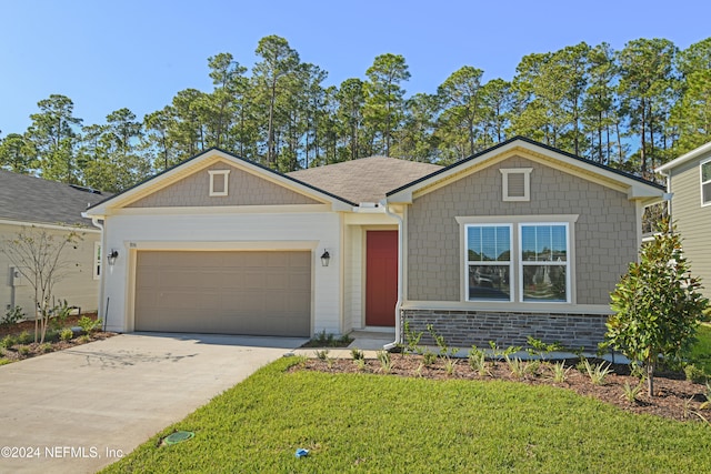 view of front of property featuring a garage and a front yard