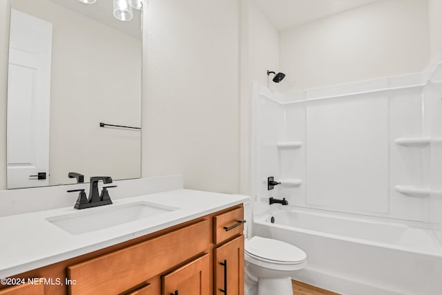 full bathroom featuring vanity, wood-type flooring, shower / washtub combination, and toilet