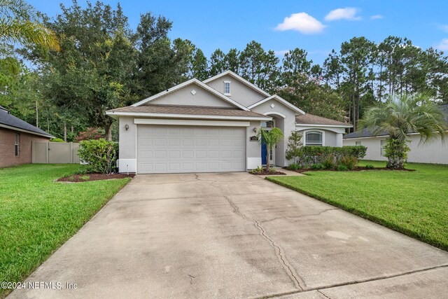 view of front of house with a garage and a front yard